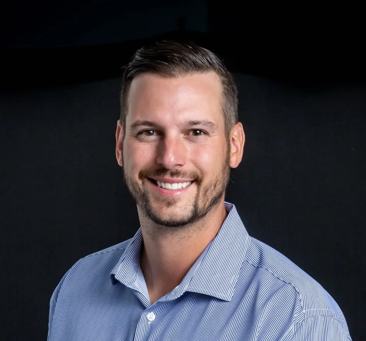 Mike Dragosavich, founder, smiling in a blue shirt