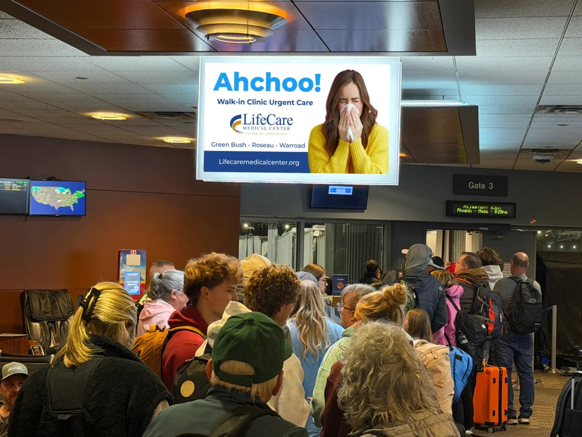 Crowded Airport Terminal With Advertisement.