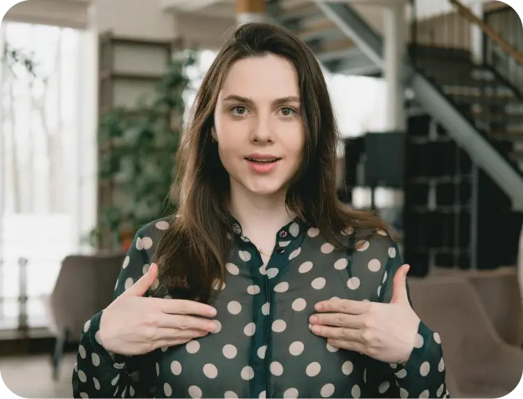 A Woman With Her Hands On Her Chest