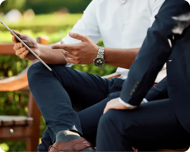A Pair Of Men Sitting On A Bench