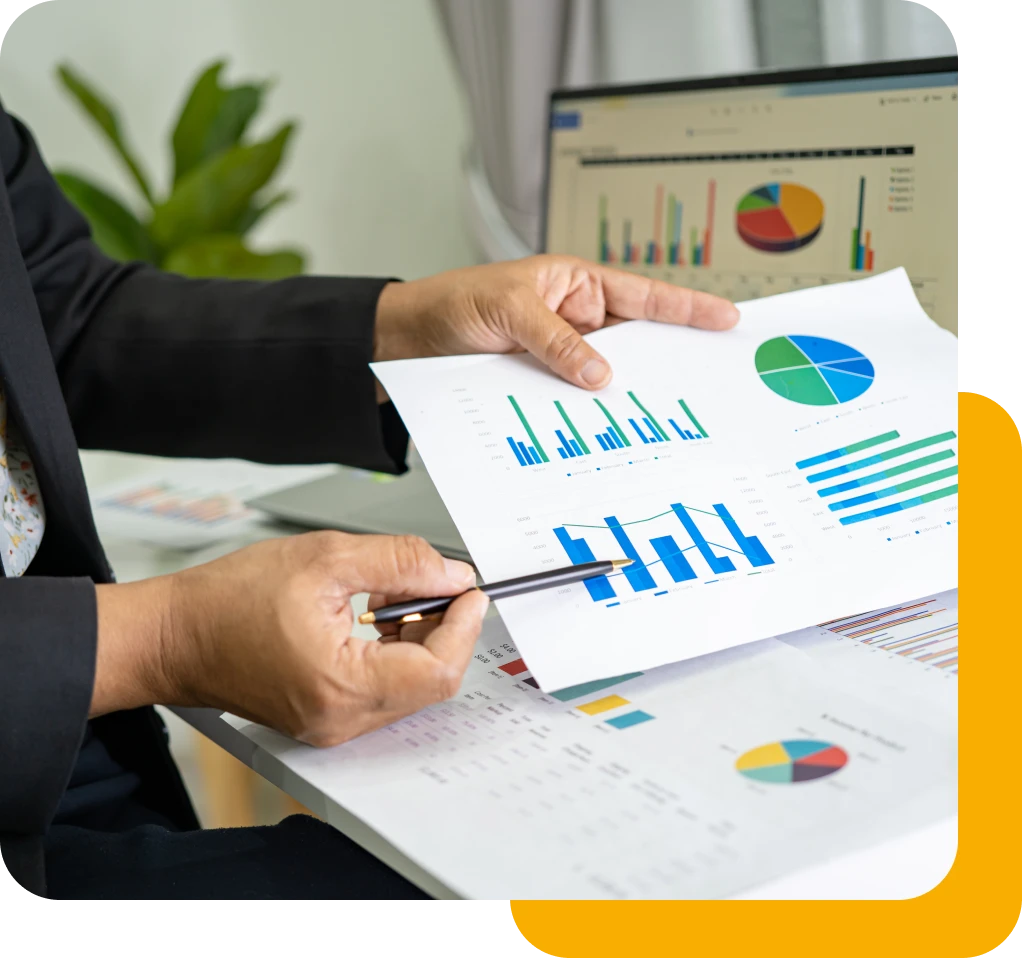 Addressable Streaming Tv Solutions A Person Holding A Pen And Paper With Graphs And Charts