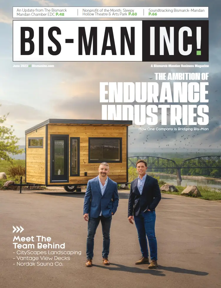 a magazine cover with two men standing in front of a tiny house