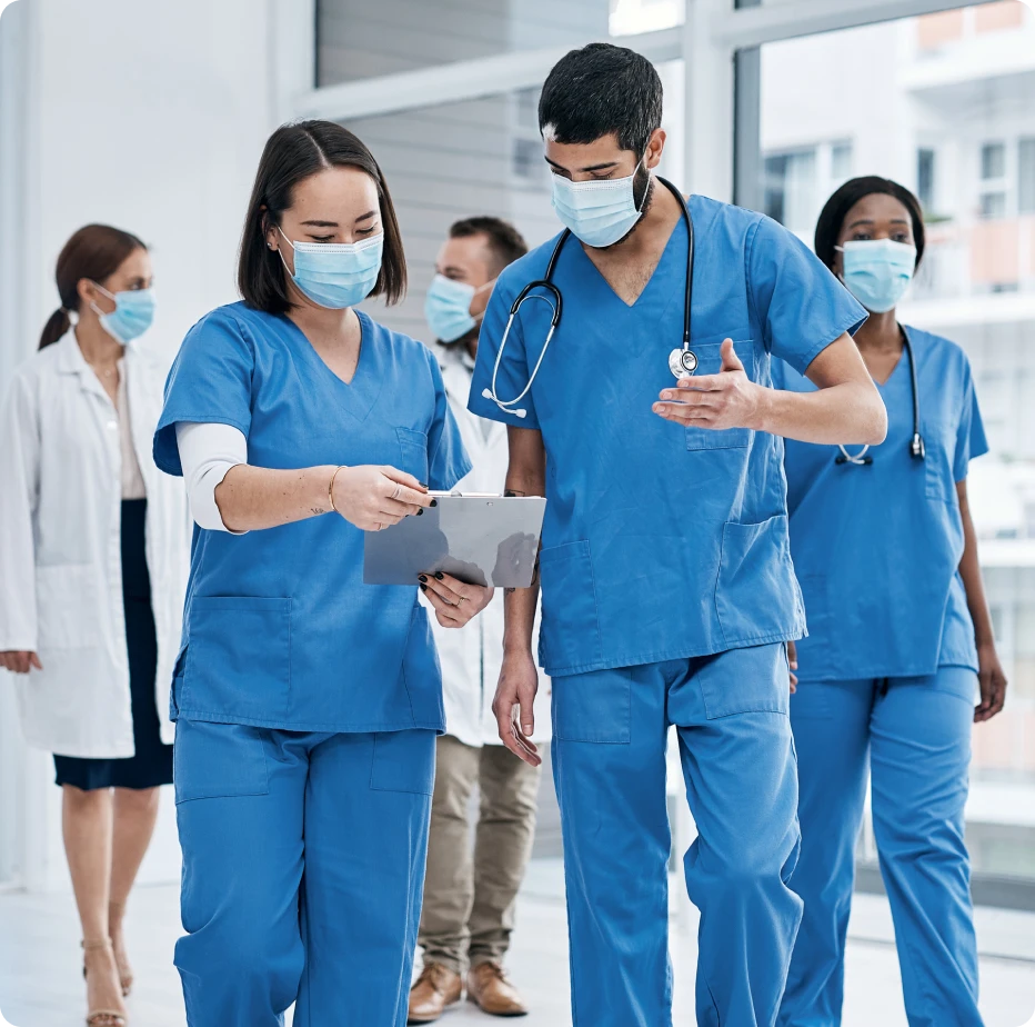 A Group Of Medical Professionals Wearing Face Masks