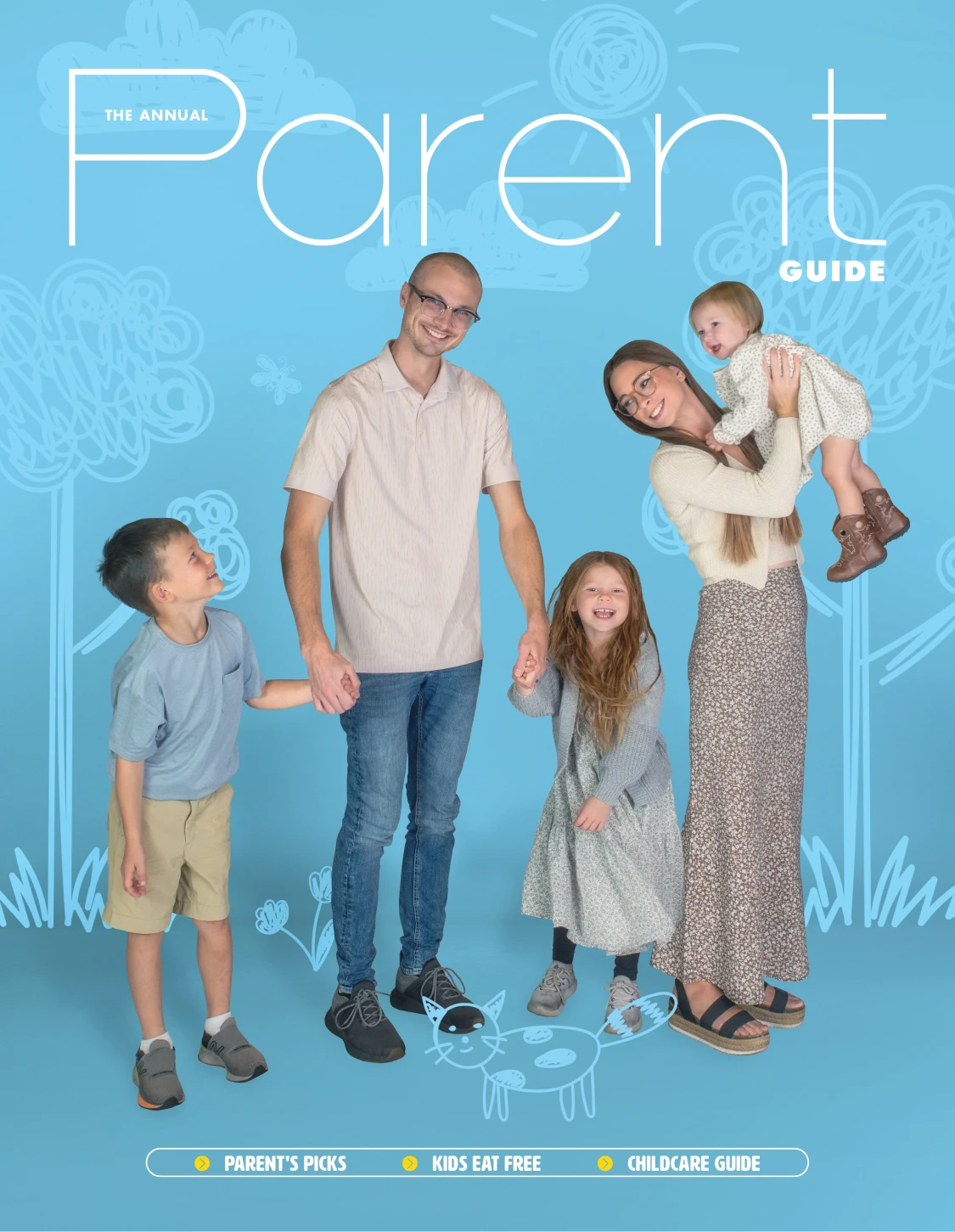 Smiling family with two daughters and a son on the Annual Parent Guide magazine cover against a blue background with hand-drawn doodles.