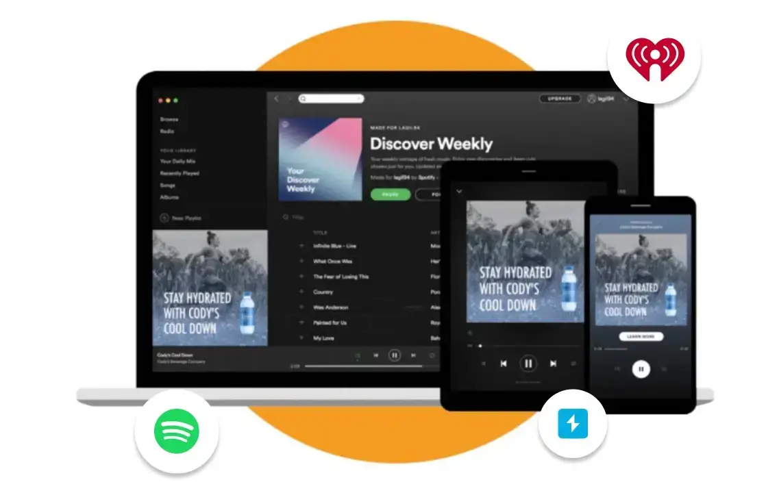 Laptop, Tablet, And Phone Showing Spotify With An Audio Ad, Plus Spotify And Iheart-Style Logos.
