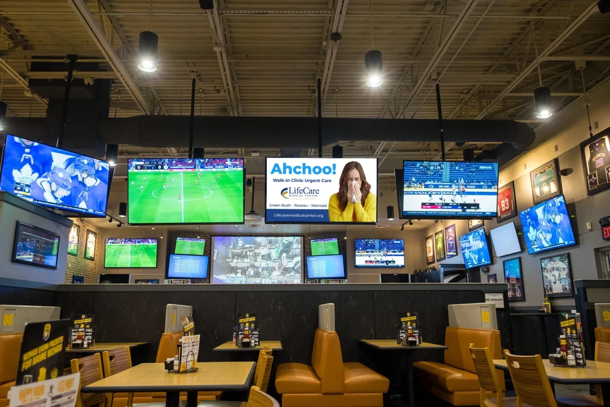 Sports Bar With Multiple Screens Displaying Games.