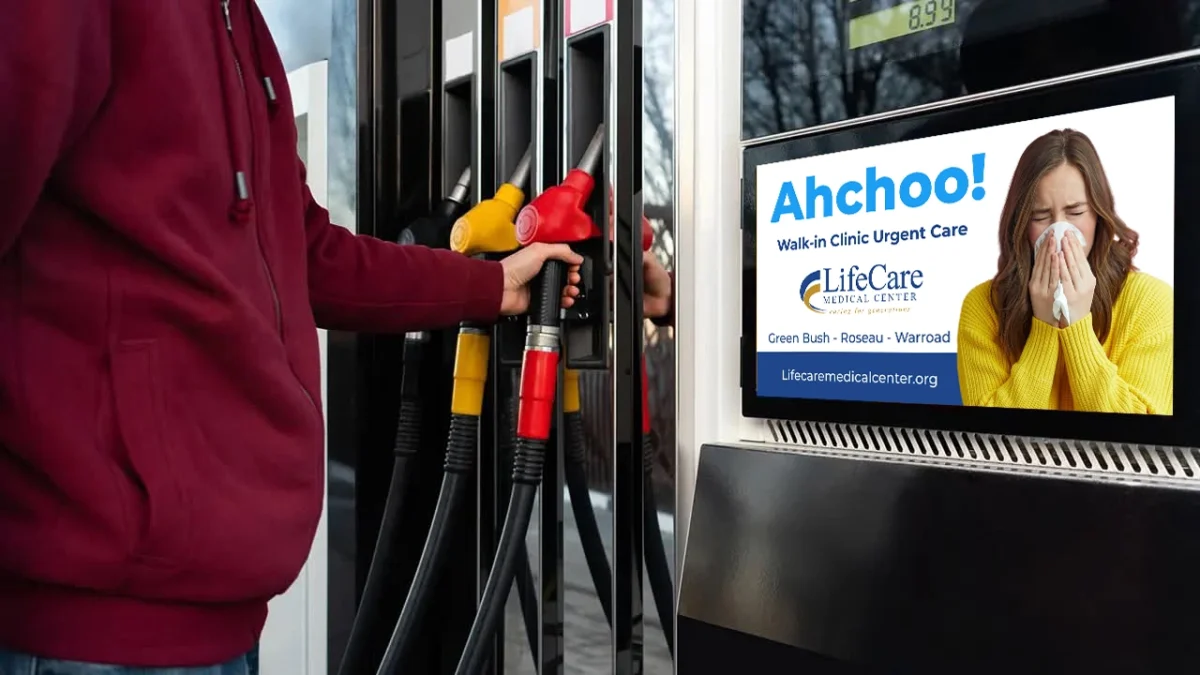 Person At Gas Station With Advertisement